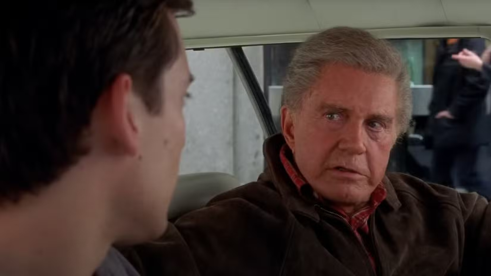 Uncle Ben sitting in a car talking to Peter Parker in Spider-Man